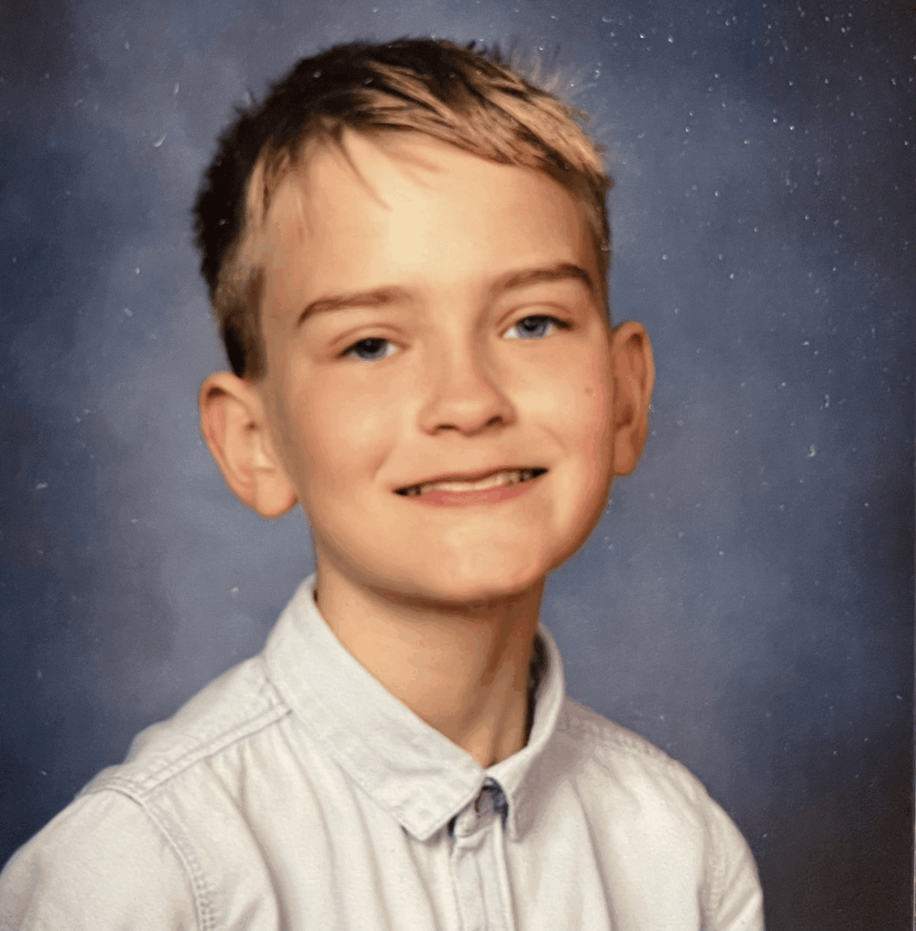 Charlie, the young intern at Aerodynamic Dreams, smiling confidently in a casual setting.